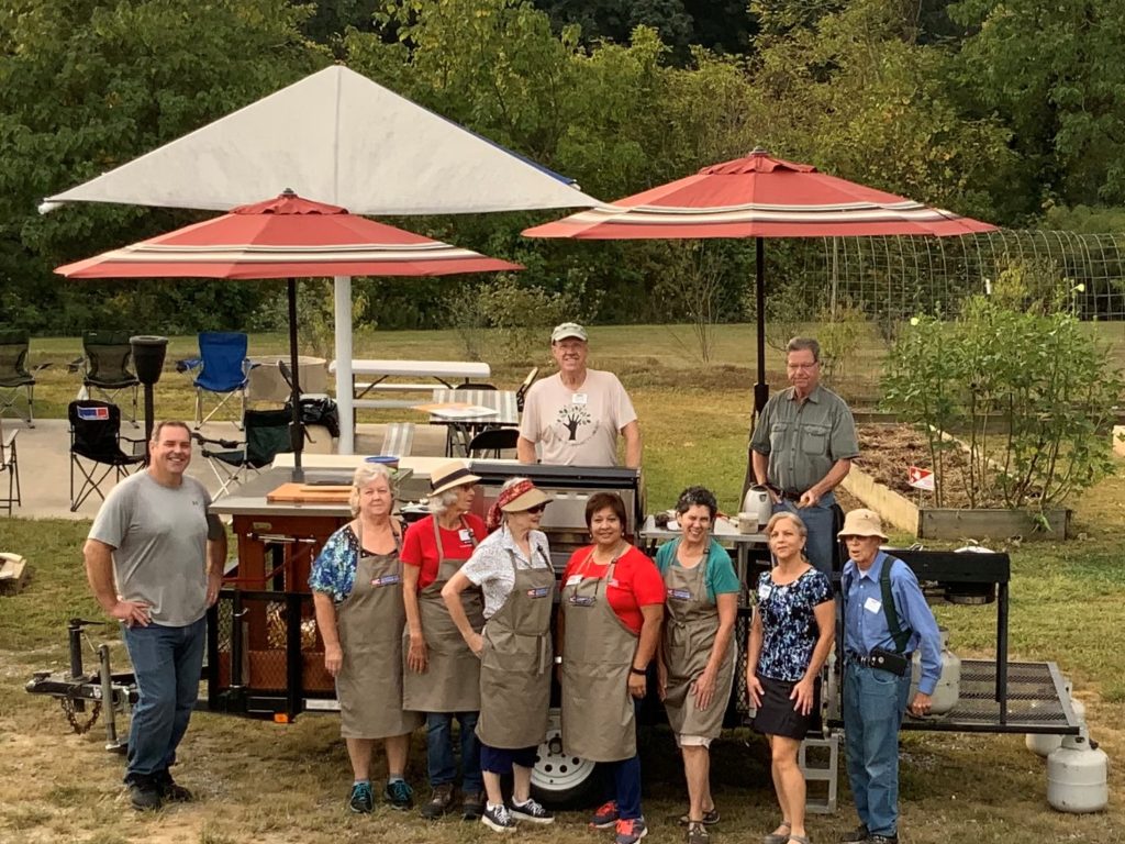 volunteers at an outdoor cooking demonstration