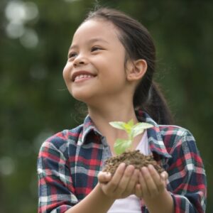 girl holding seedling