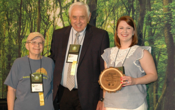 Master Gardener volunteers receiving award plaque.